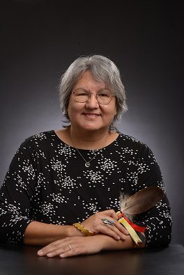 Melanie Goodchild holding feather